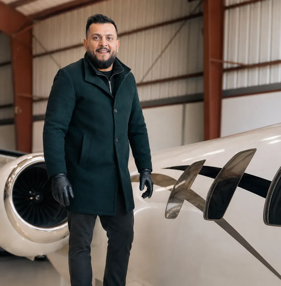 Karan Gogna, founder of JetSpa, beside a business jet in a hangar