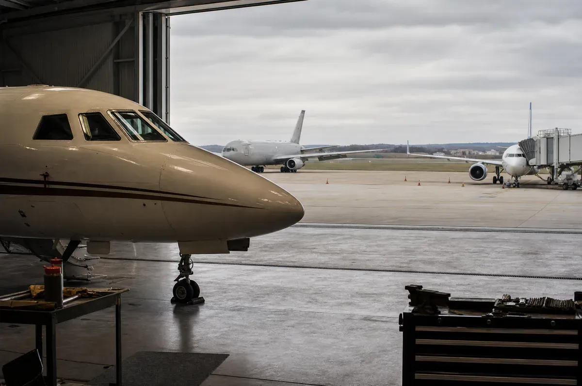 A business jet on a ramp shared with commercial and cargo operations