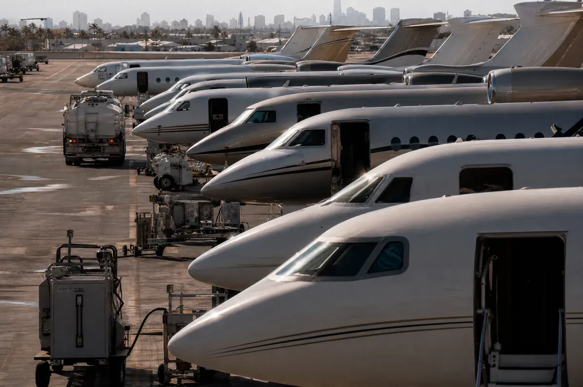 A densely packed business aviation ramp with jets parked wingtip to wingtip
