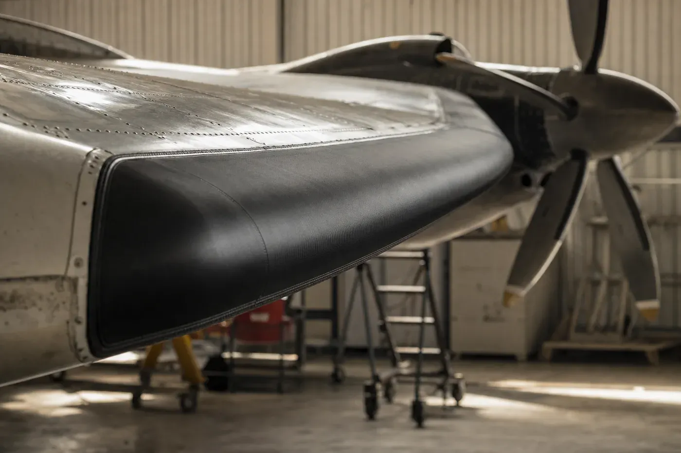 A freshly conditioned black de-ice boot on a twin turboprop wing leading edge