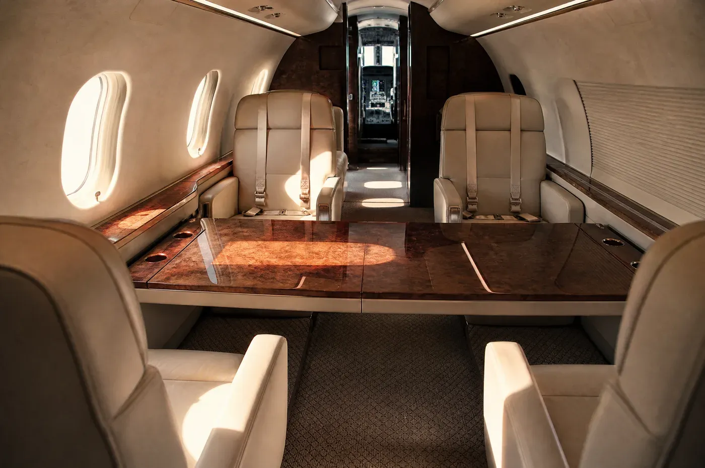A finished jet cabin looking forward, club seats squared and belts laid flat